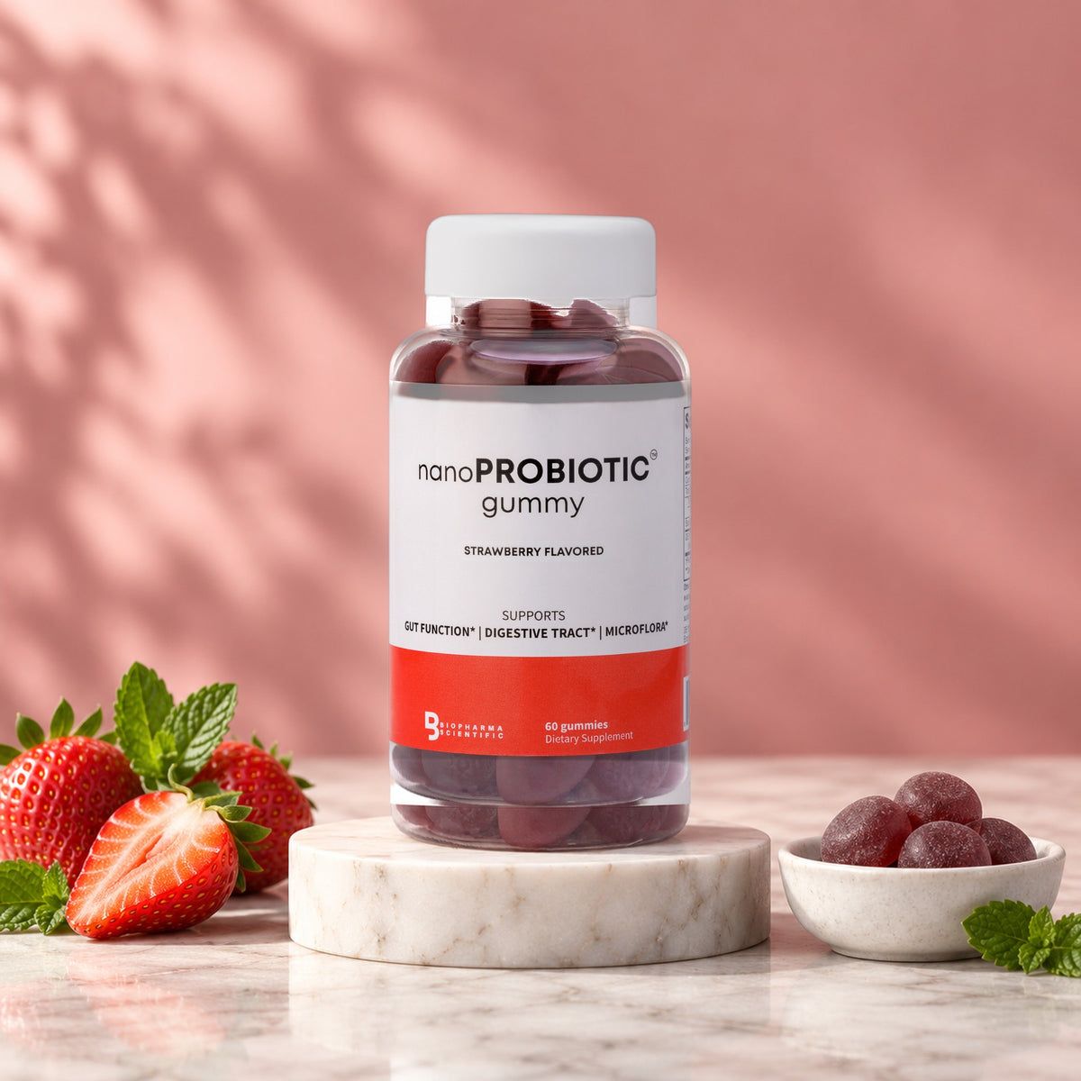 NanoProbiotic Gummies jar in a bright studio still life with fresh ingredients